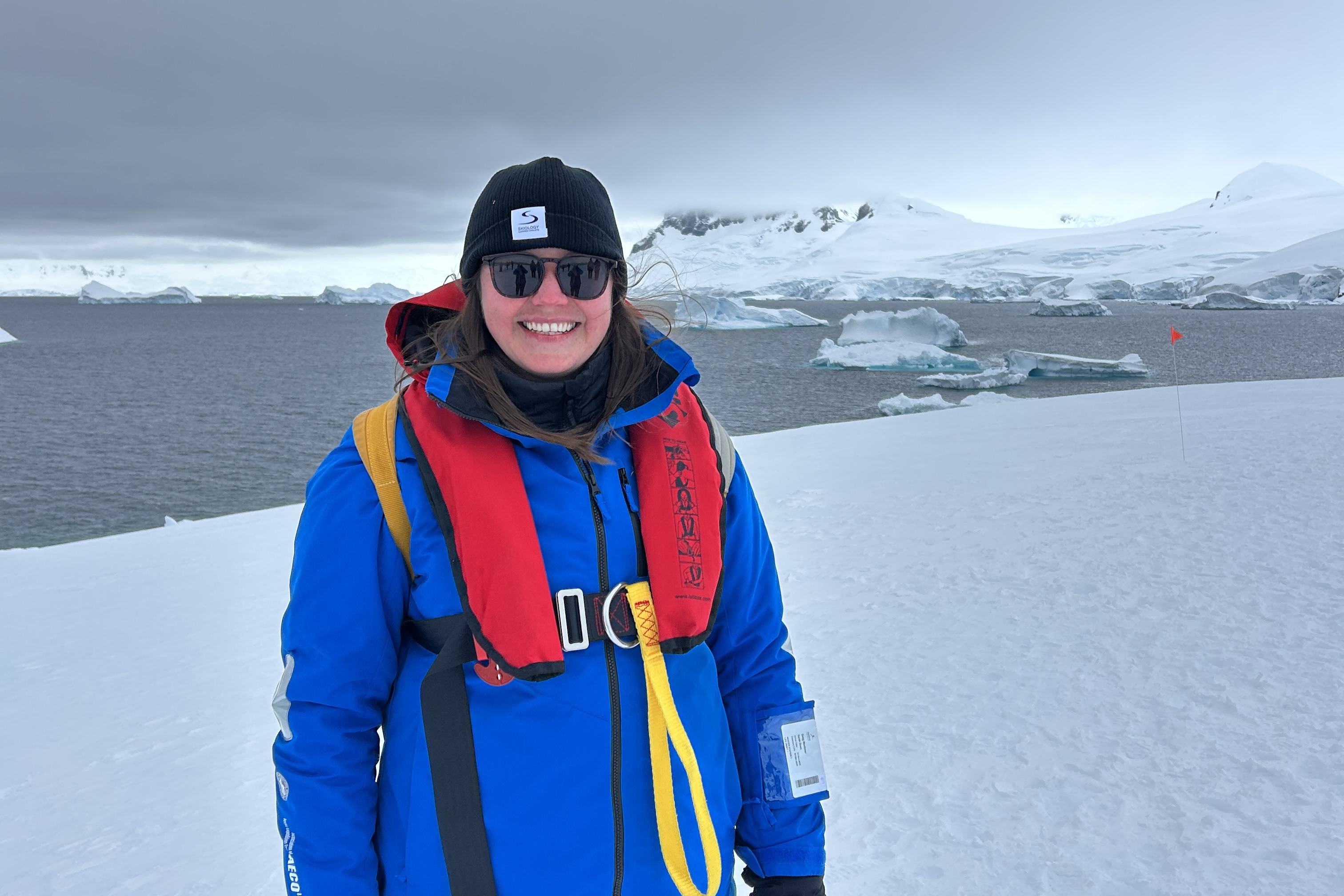 Portrait of Sarah in front of an icy Antarctic landscape
