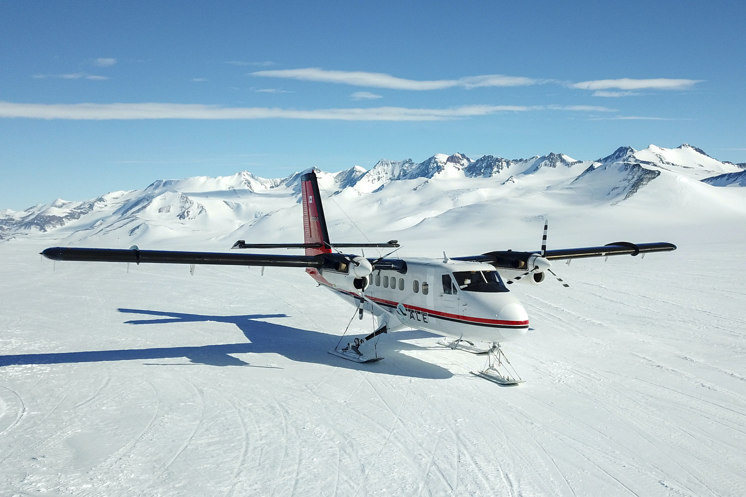 Twin otter plane with skis at remote Antarctic landing strip