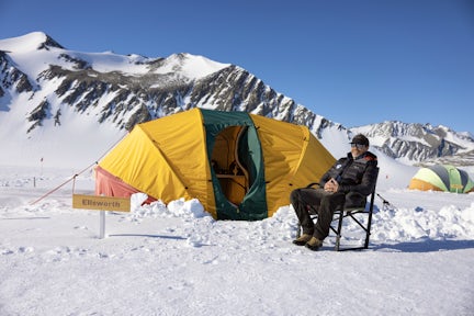 Person sitting outside a tent Union Glacier Camp in Antarctica