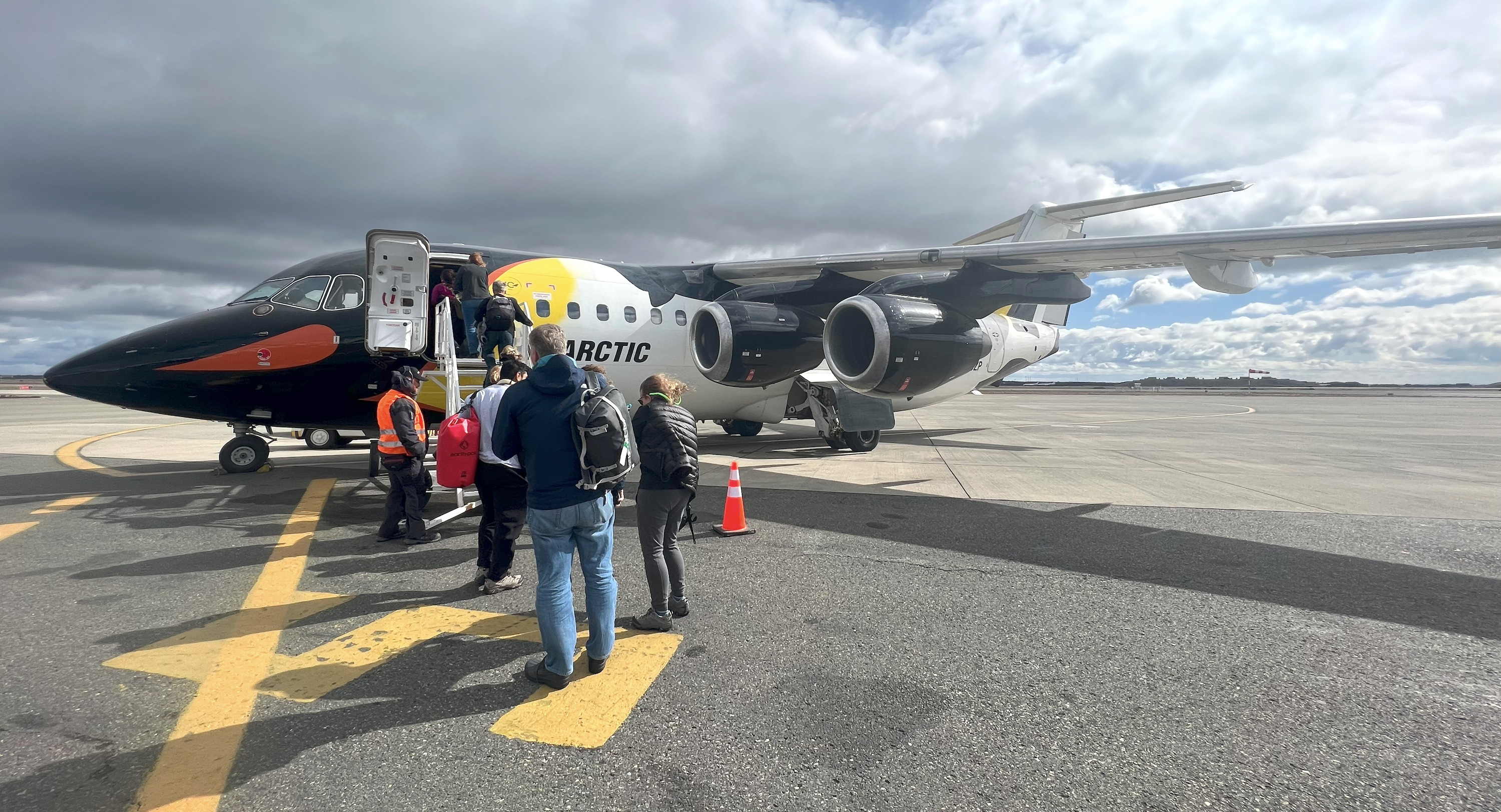 Travellers line up to board the charter plane to Antarctica
