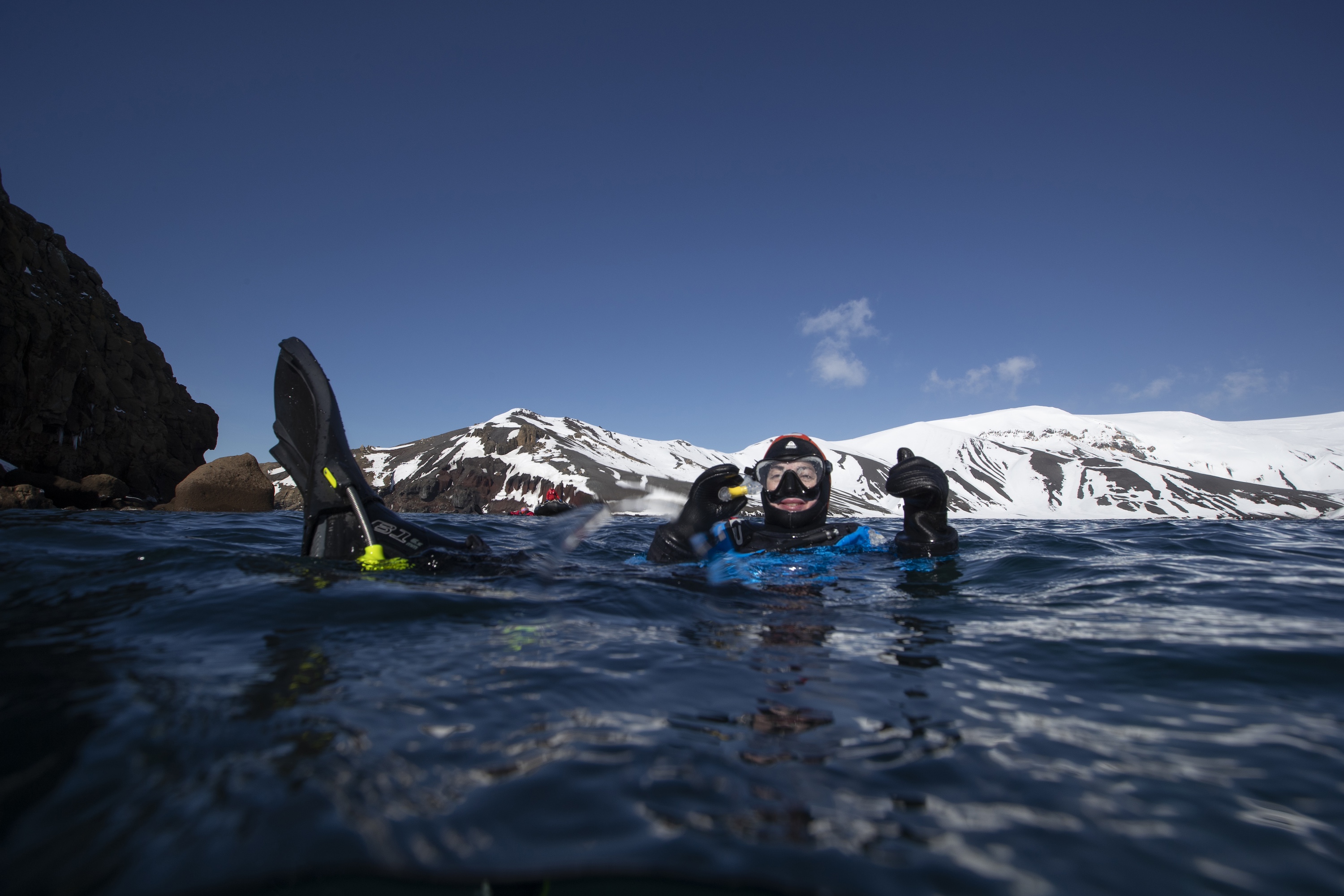 Snorkeller gives a thumbs up while in the Antarctic waters