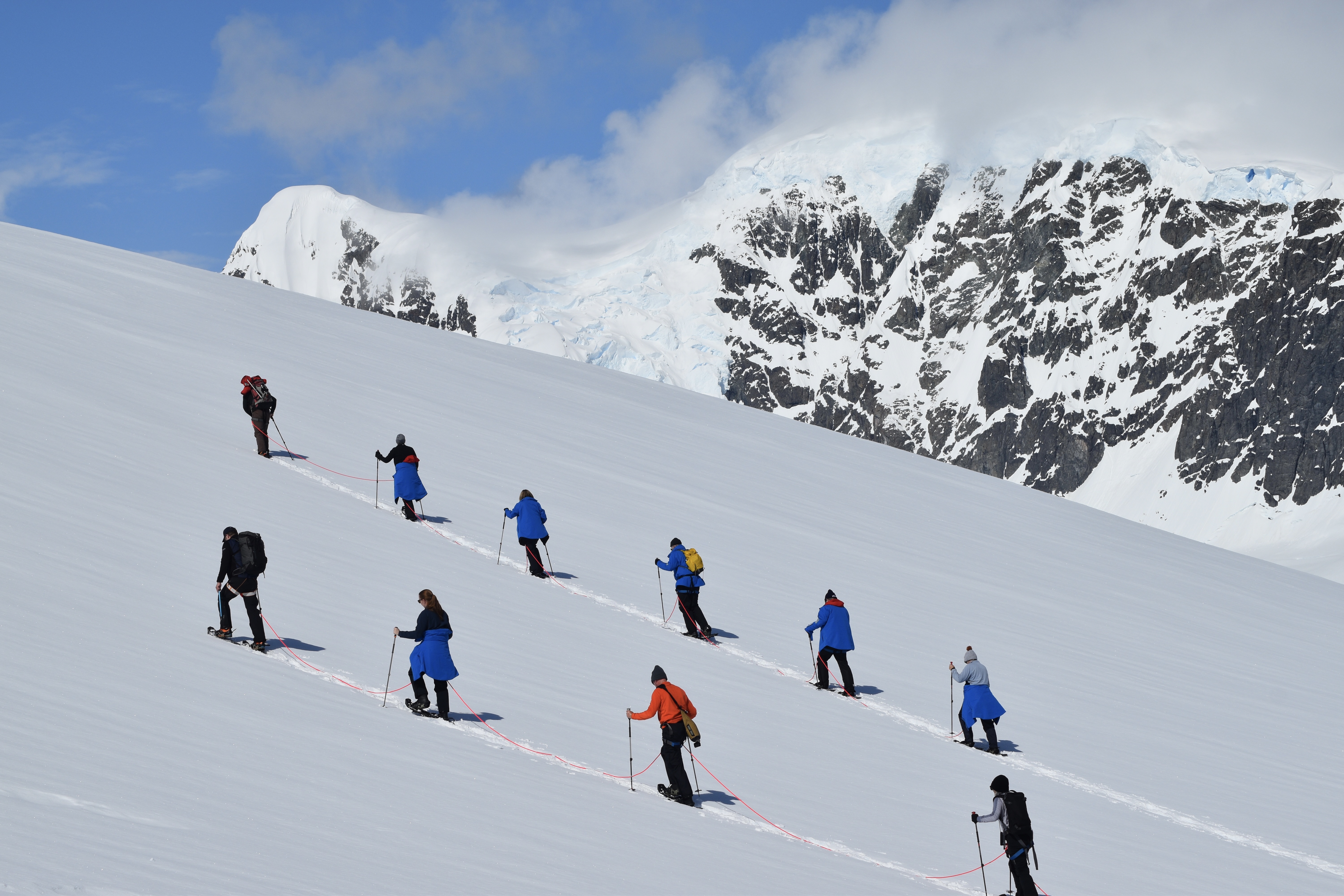 A group of Snowshoers hiking up a hill on Danco Island