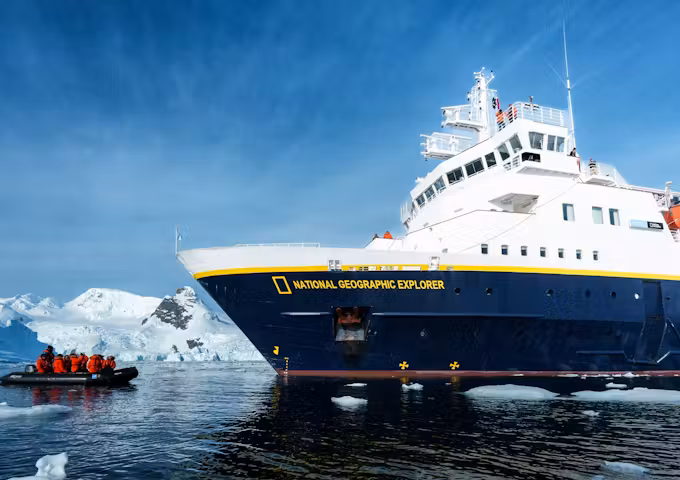The National Geographic Explorer Antarctic ship and a zodiac sail in Antarctica