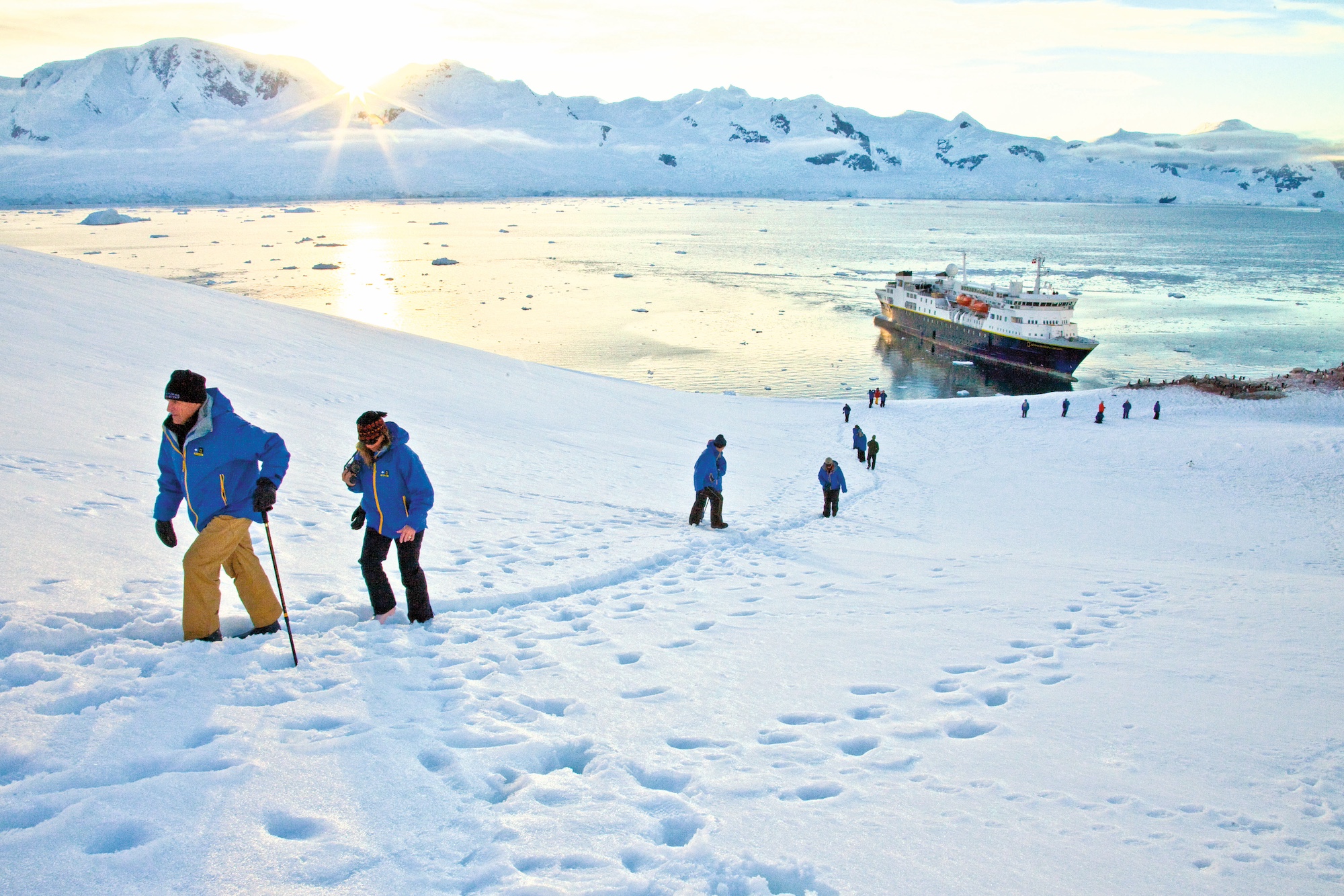 Travellers walk through the snow at Neko Harbour, Antarctica