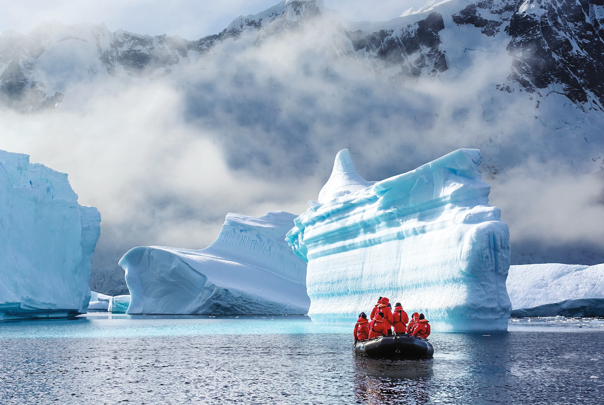 Zodiac cruising past icebergs of Booth Island 