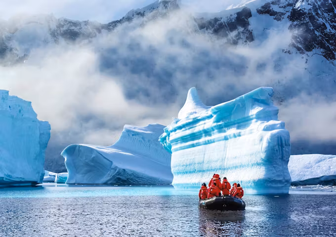 Zodiac cruising past icebergs of Booth Island
