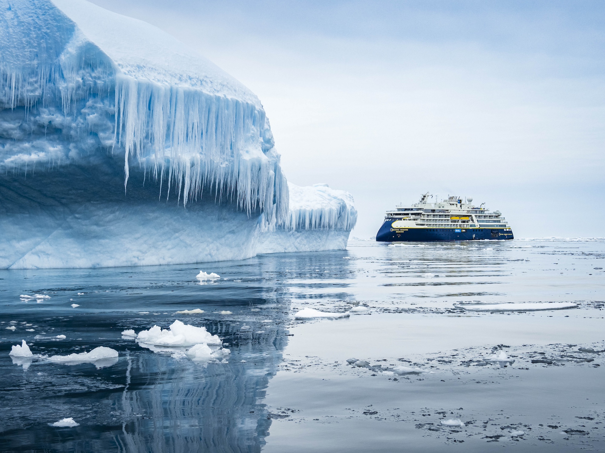 Icebergs dwarf a vessel in Antarctica