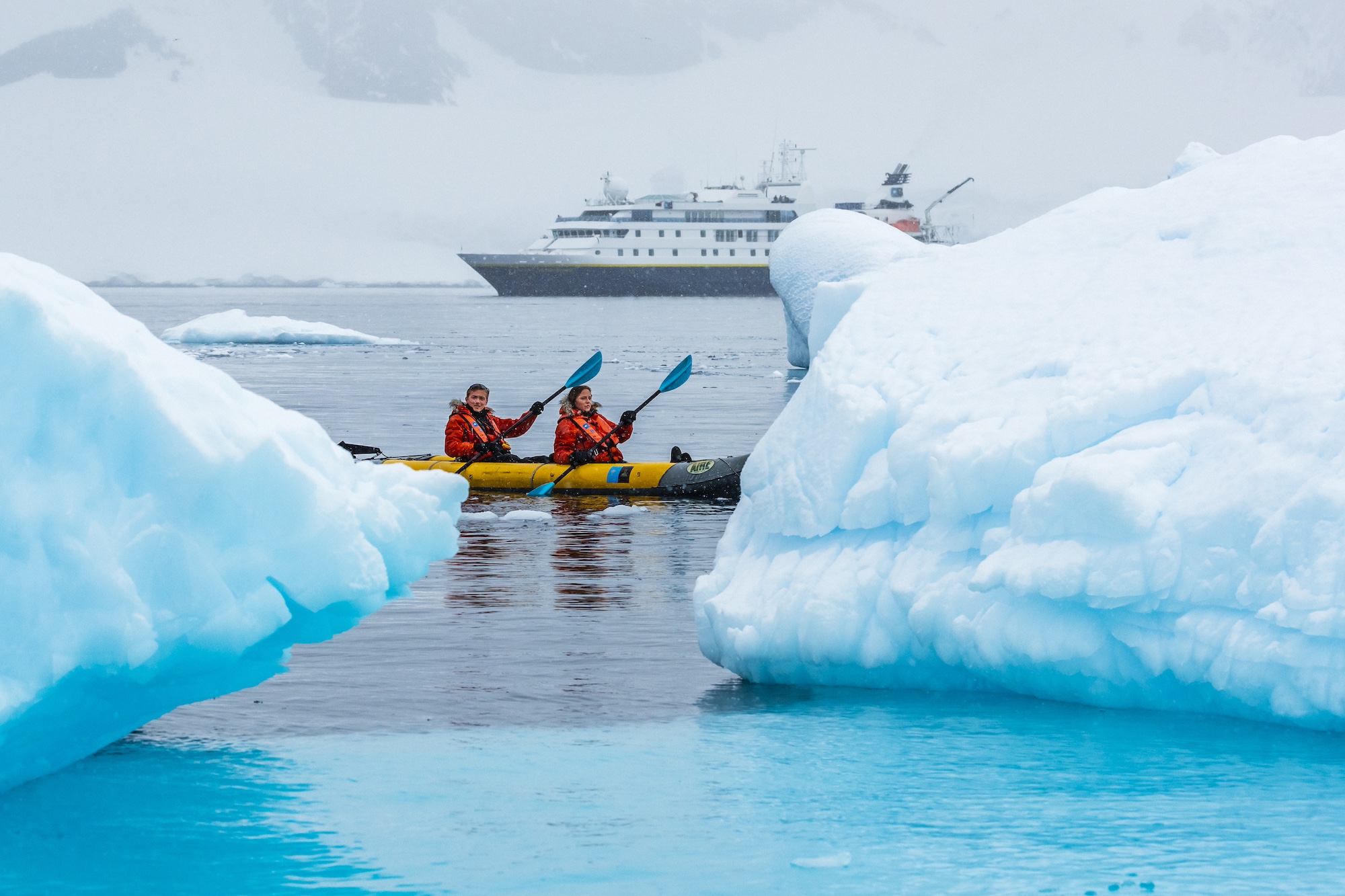 Kayakers paddle around ice in Antarctica