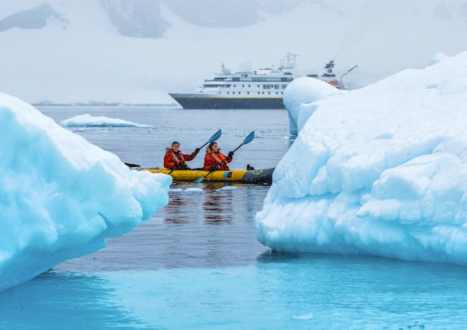Kayakers paddle around ice in Antarctica