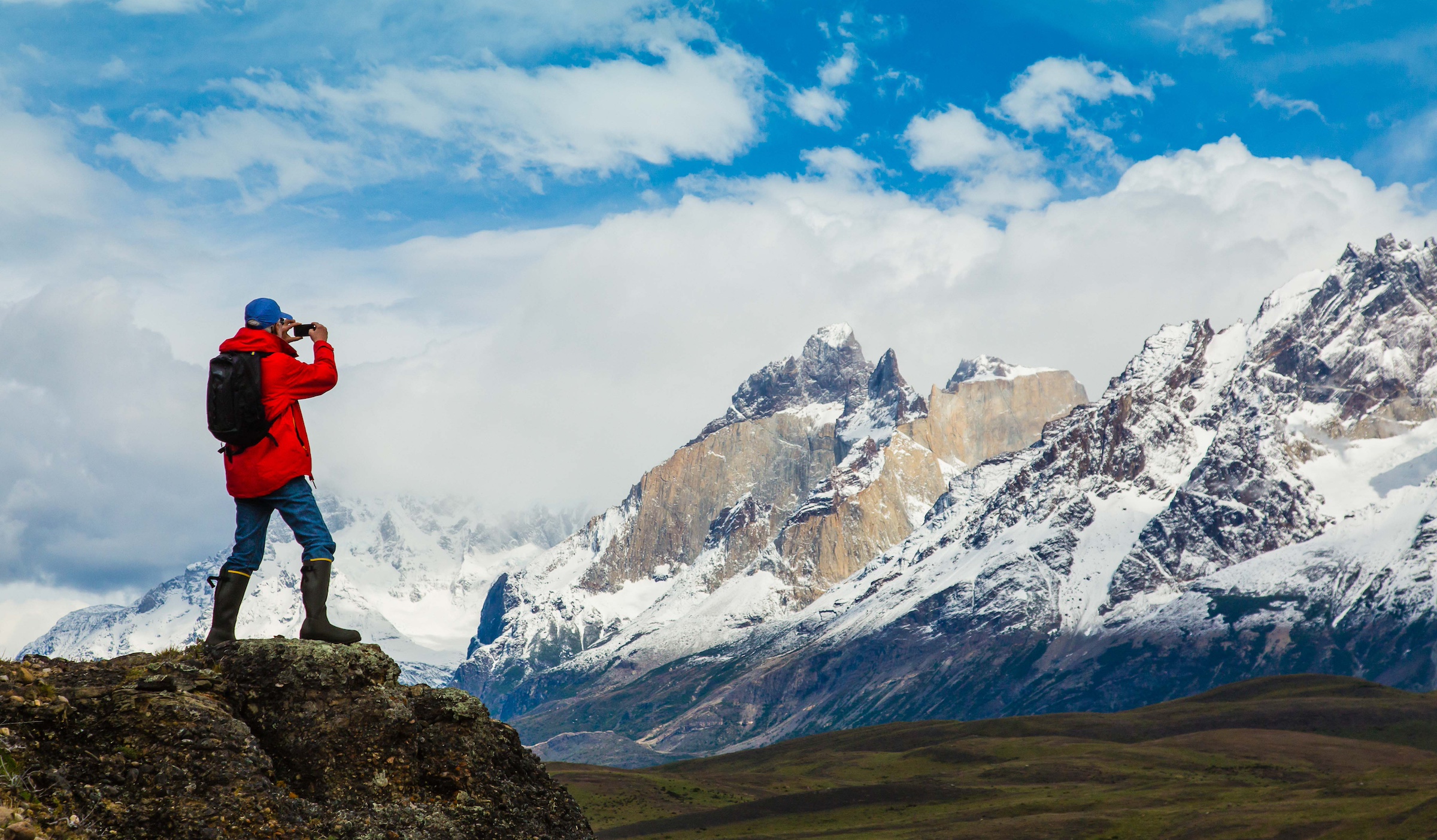 A man takes a photograph of the peaks in Torres del Paine National Park, Chile