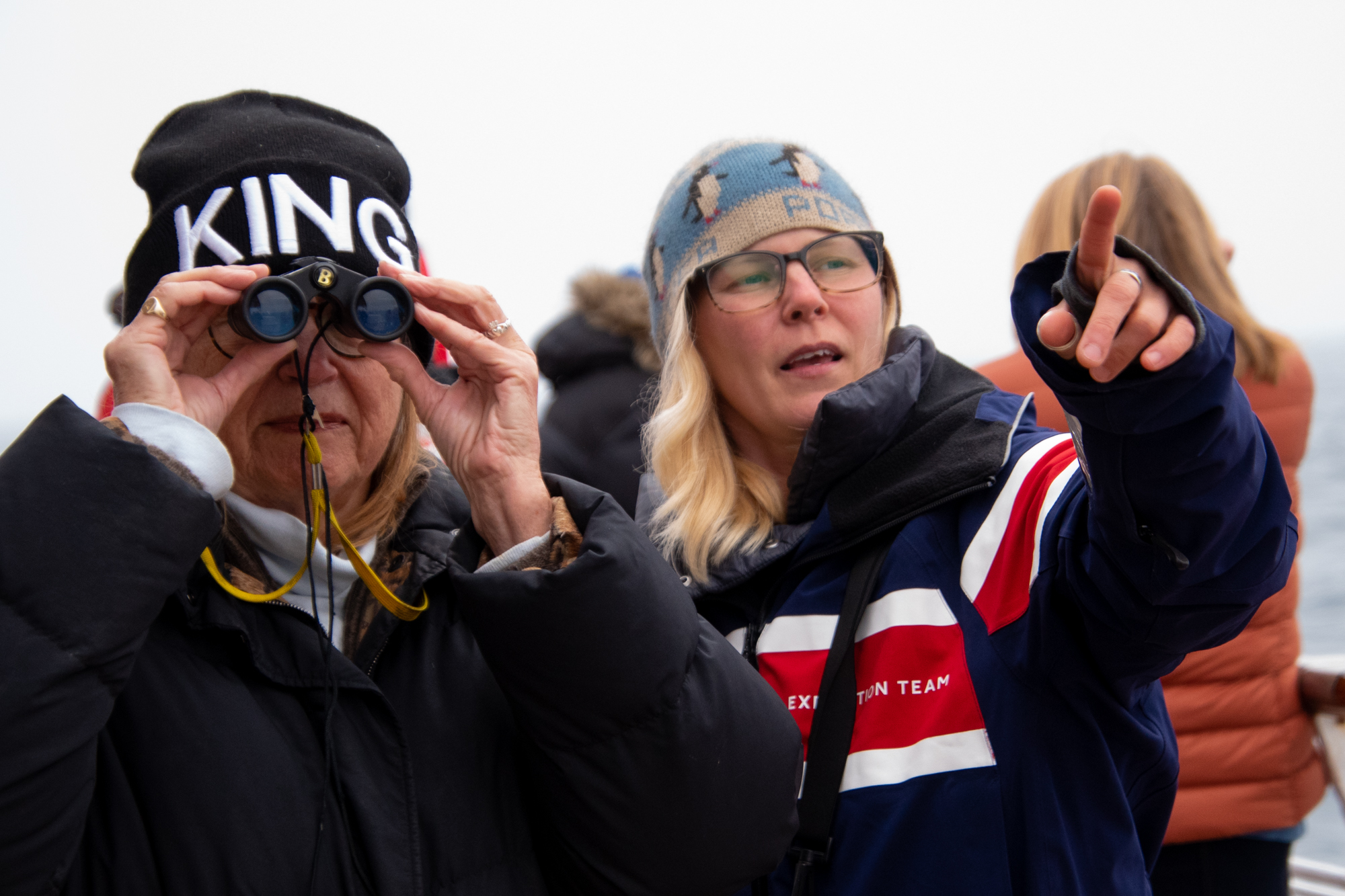 A naturalist guide with a passenger in Antarctica