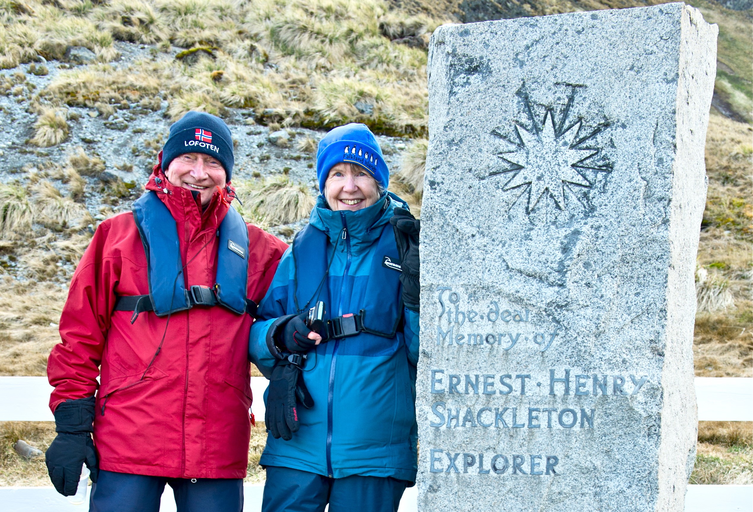 Two tourists by Shackleton's grave at Grytviken in South Georgia