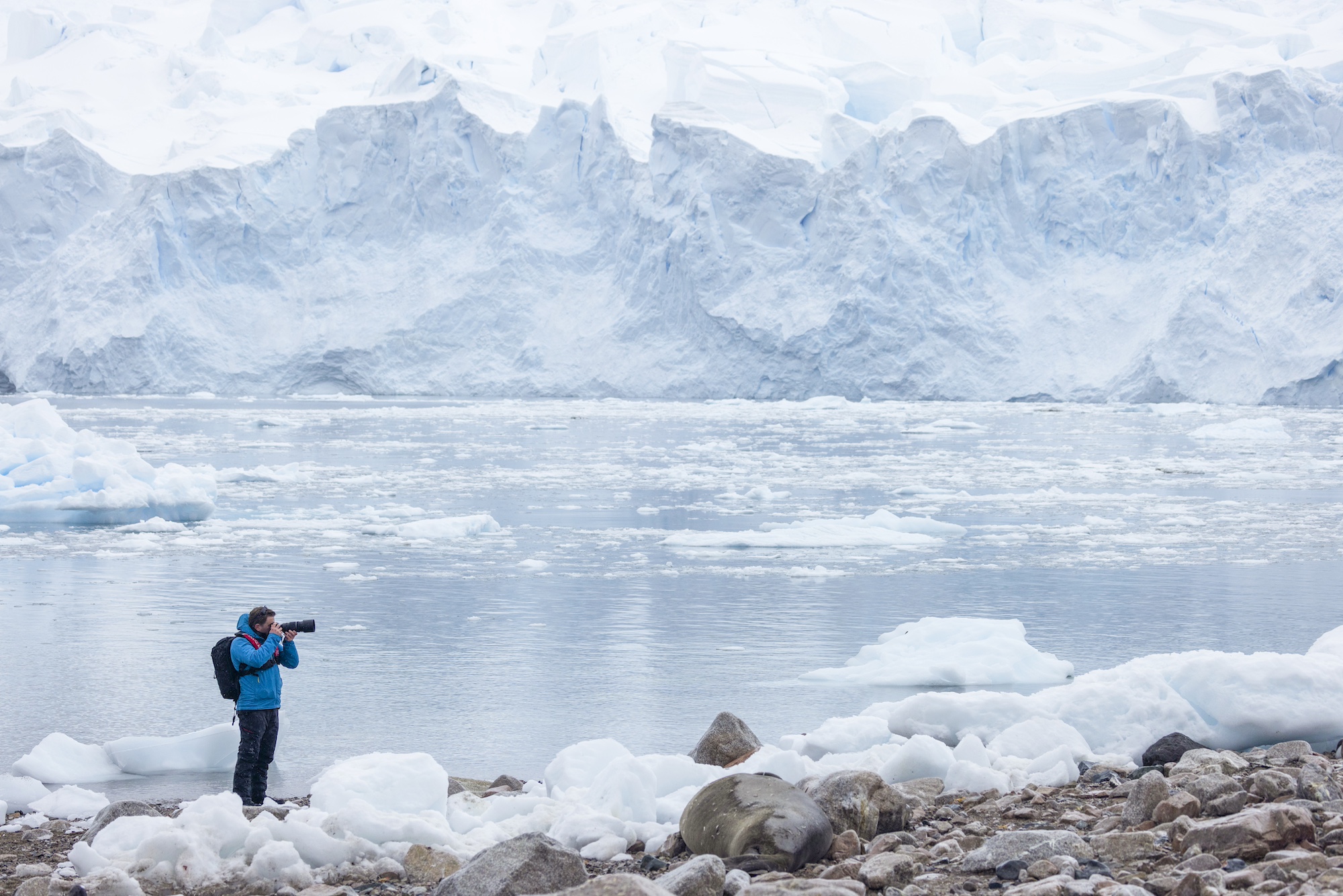 A man takes a photo in Antarctica