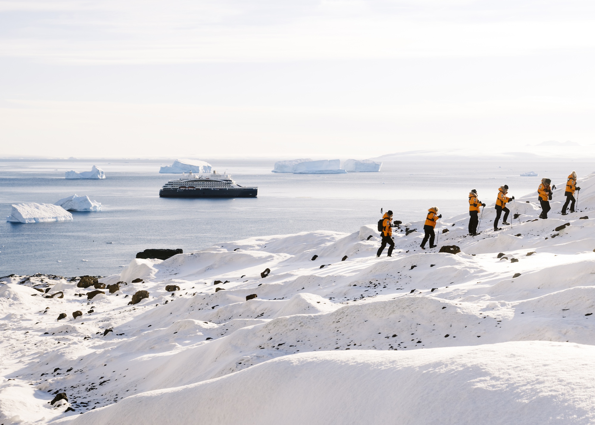 A group hikes up an Antarctic mountain in the Weddell Sea