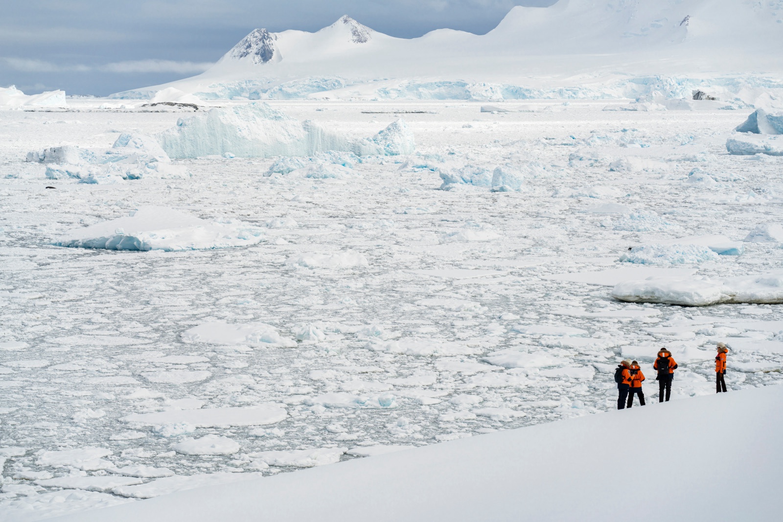 Travellers wander across Stonington Island in Marguerite Bay 