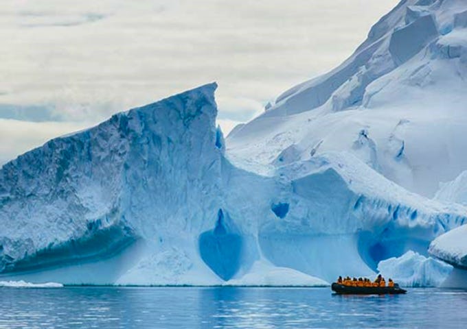 Zodiac boat in front of icebergs, Antarctica