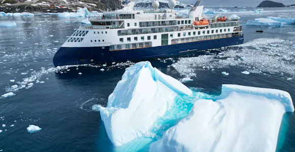 The Antarctic ship the Ocean Explorer and two large icebergs 
