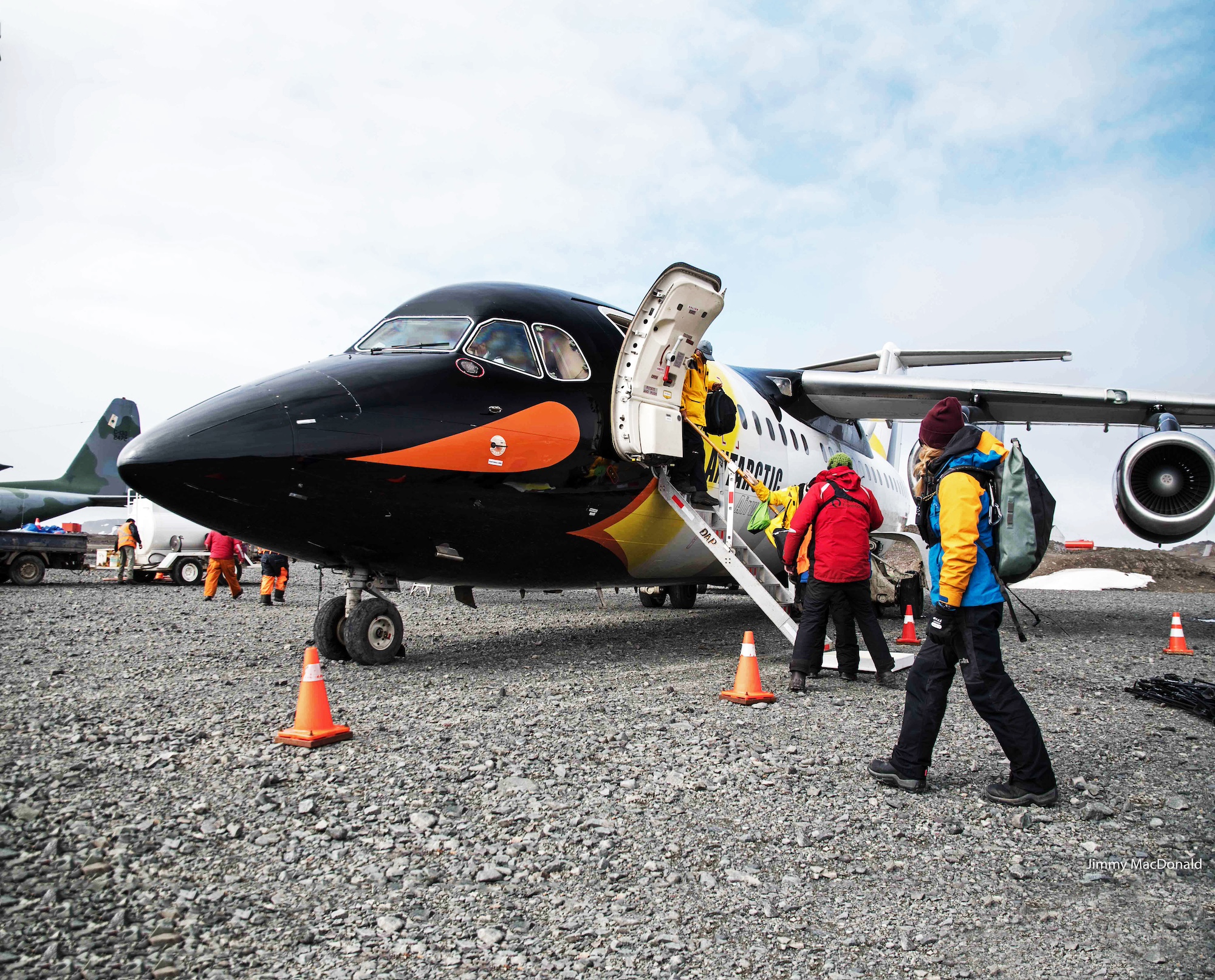 Guests embark on a plane painted to look like a penguin in Antarctica 