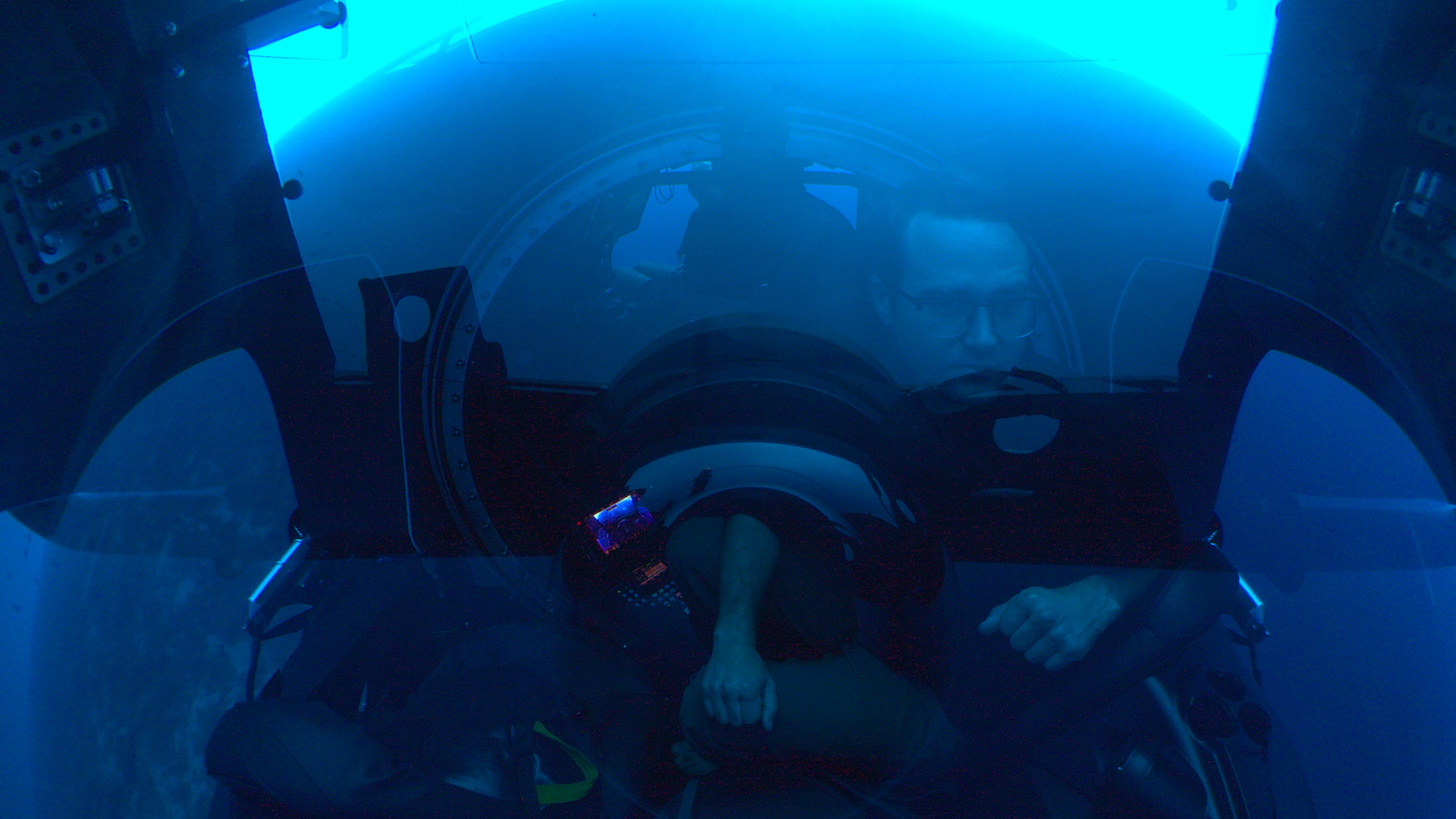 A pilot drives a submarine underwater