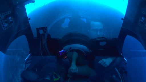 A pilot drives a submarine underwater