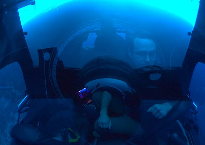 A pilot drives a submarine underwater