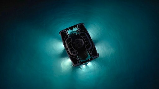 An eerie interplay of light and dark forms outside a submarine sinking into the sea