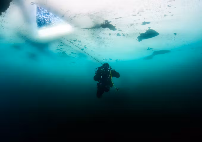 Scuba diver under the ice Antarctica