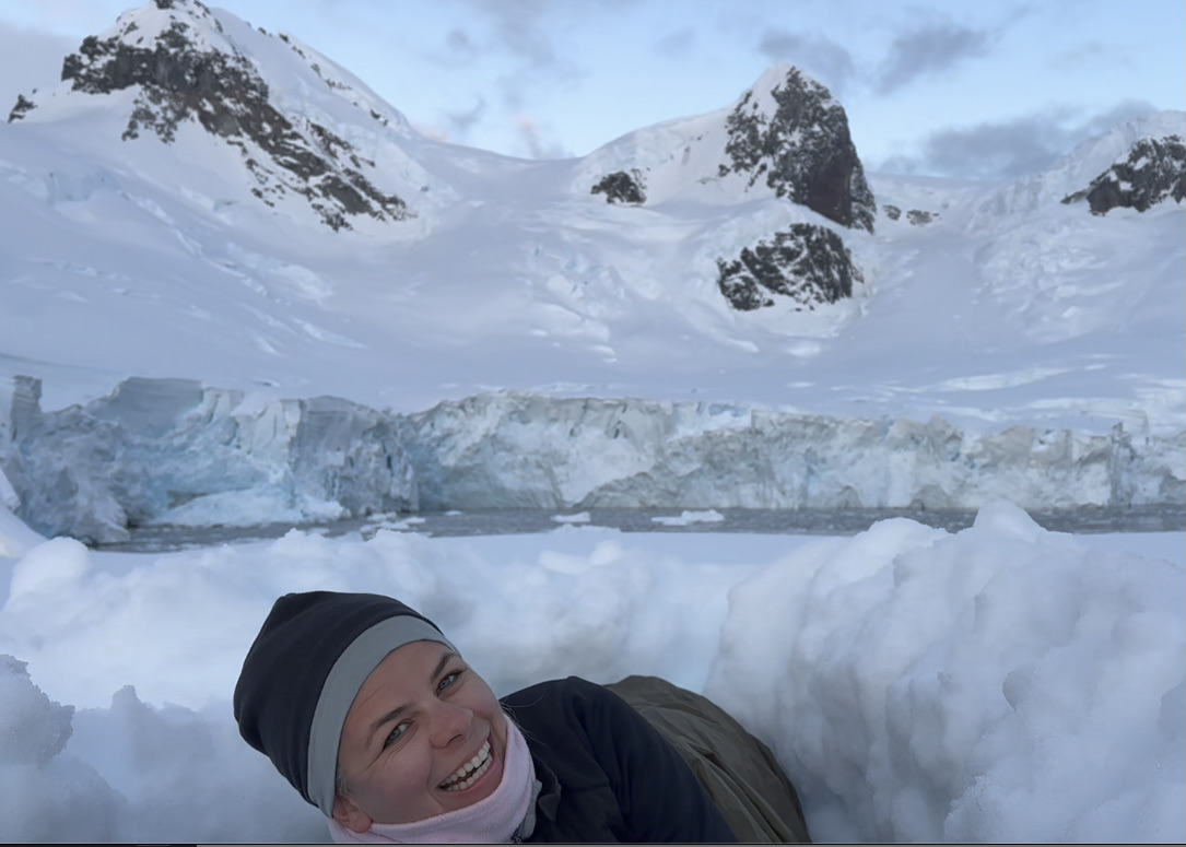 A tourist camping in a snowhole in Antarctica