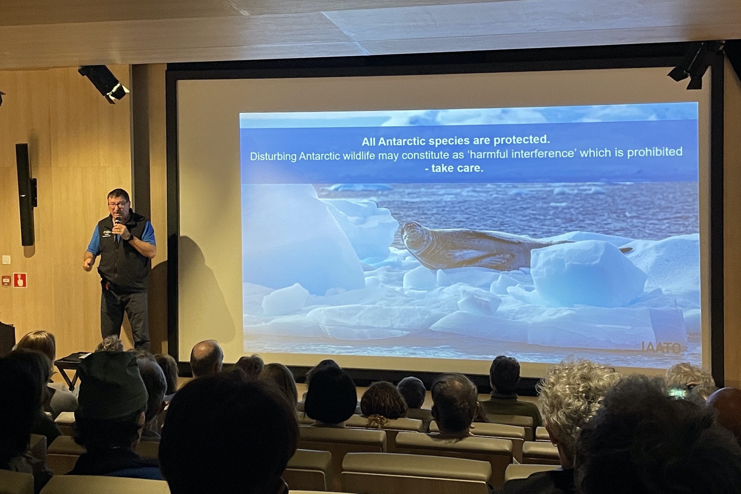 Expedition guide giving a lecture on an Antarctic cruise ship