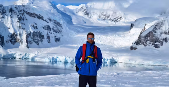Swoop team member Daniel stands in the snow in Antarctica