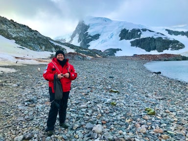 Swoop CX team member Kate Higgs stands on Cuverville Island, Antarctica