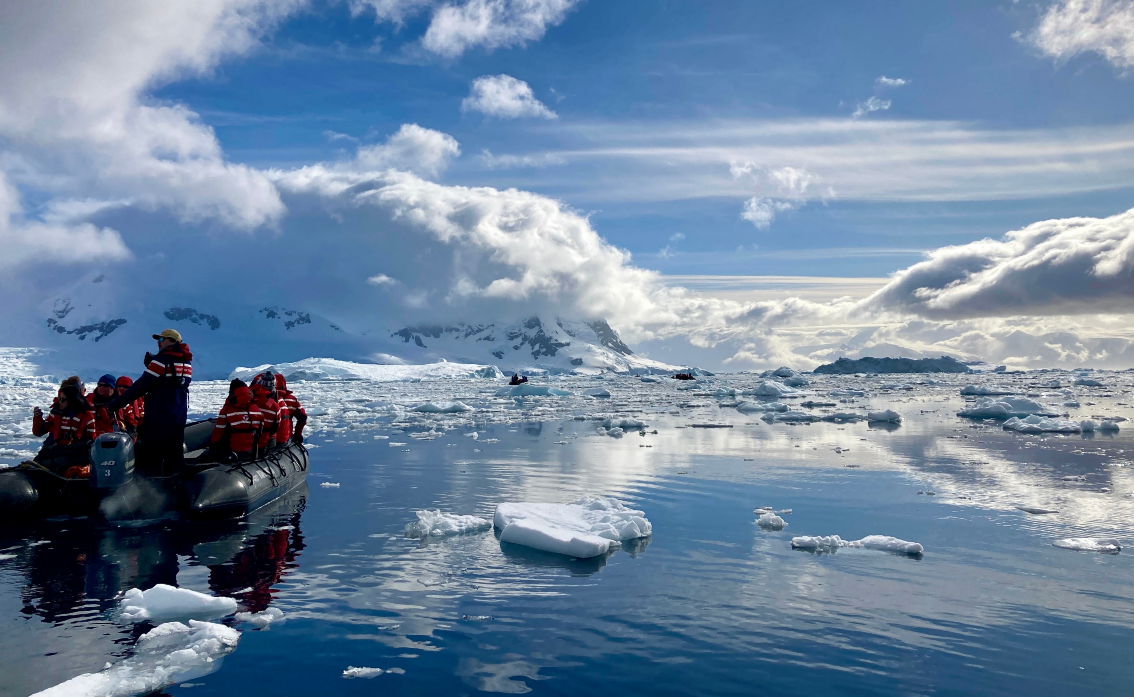 A zodiac and calm Antarctic seas