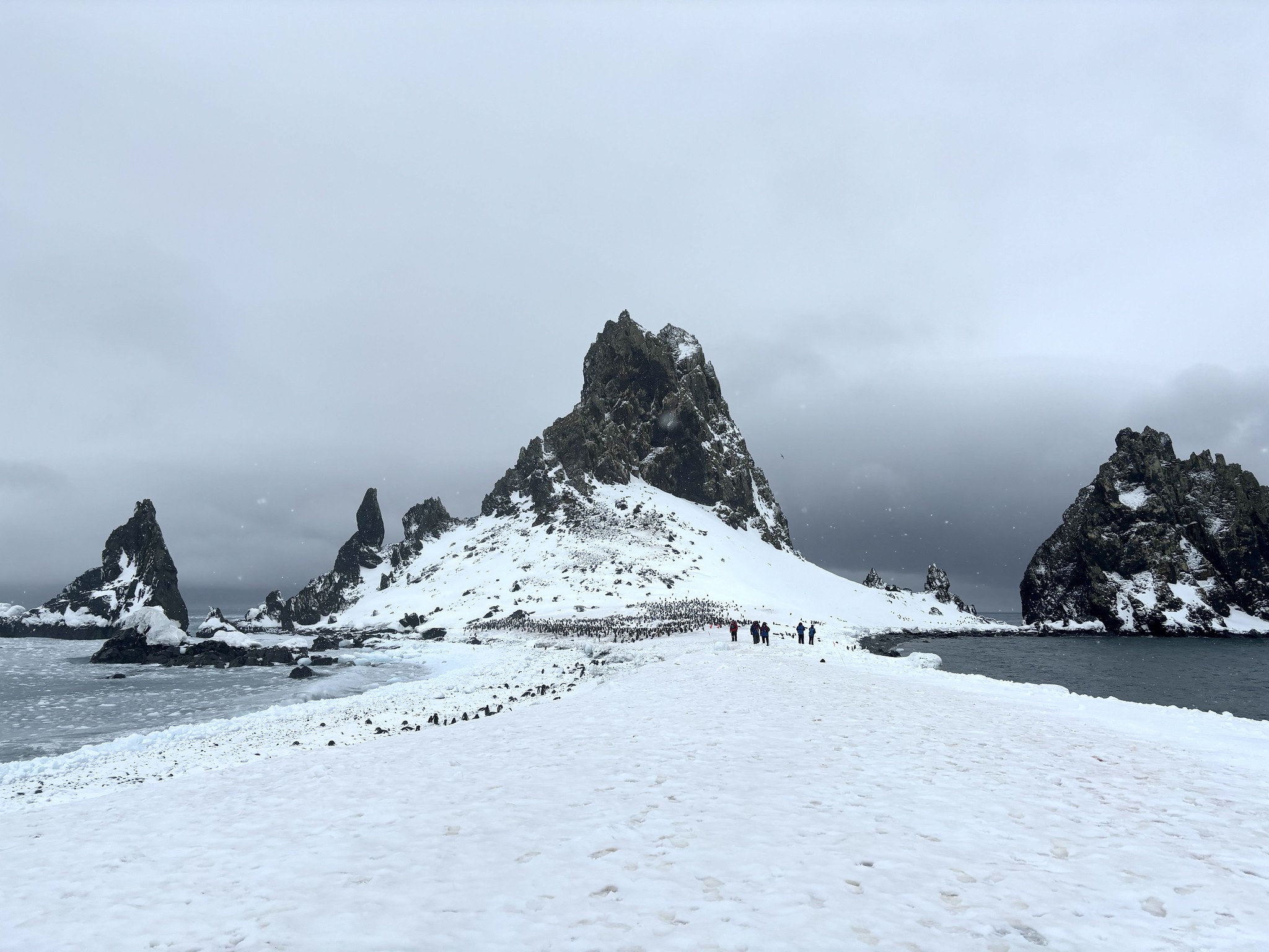 A rocky, snow-covered slither of scenery bisects a body of water