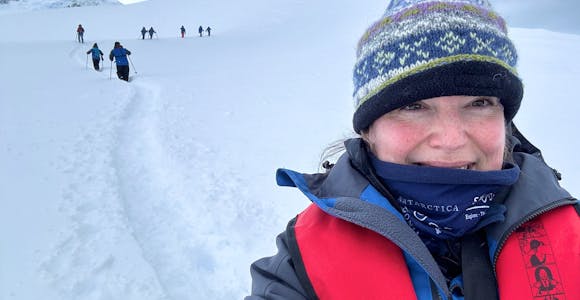 Lu, an Antarctic sales team member, poses in the snow on an Antarctic landing