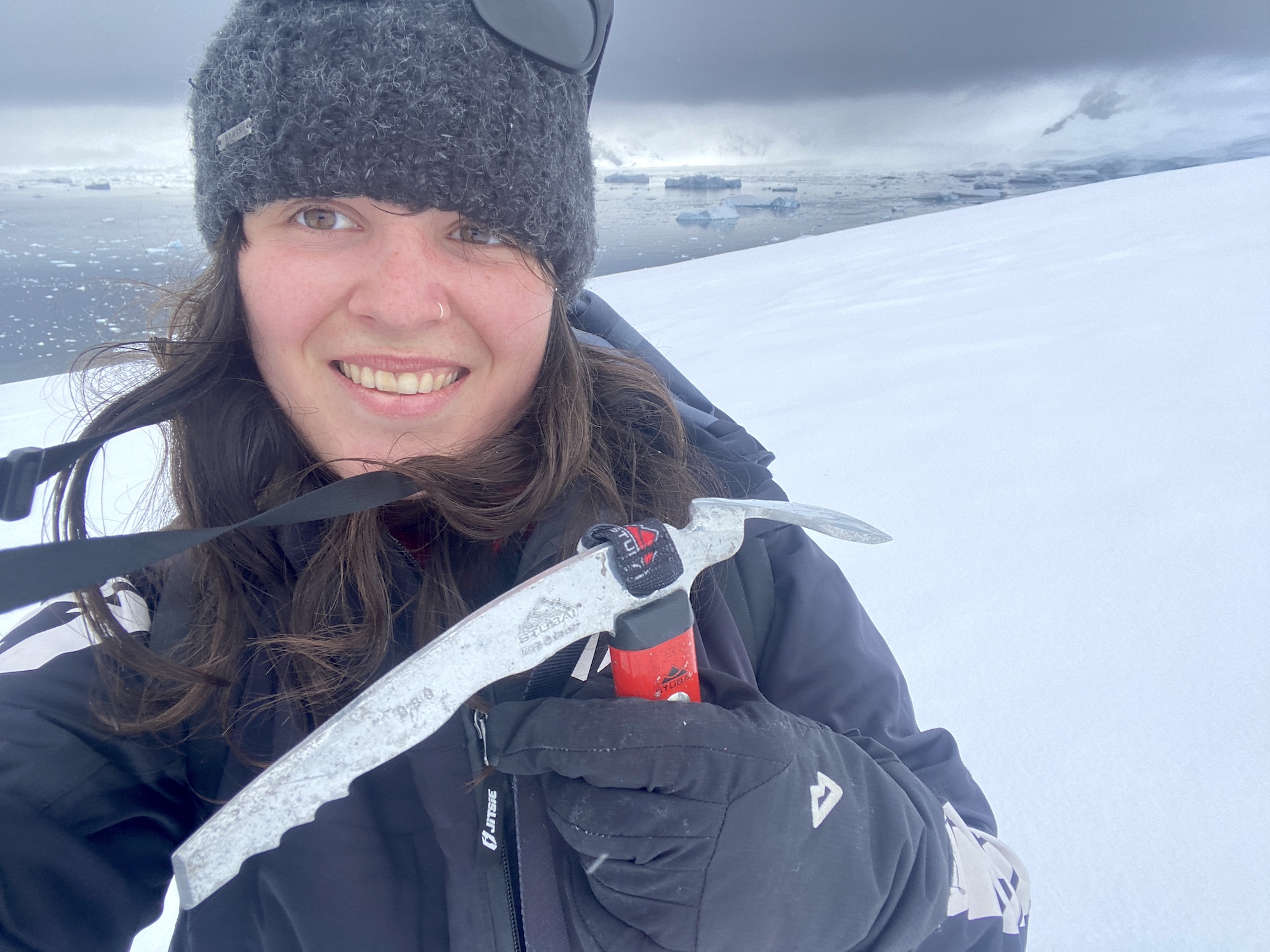 A woman takes a selfie while mountaineering in Antarctica