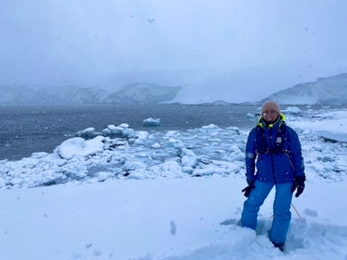 A woman poses in misty weather in Antarctica