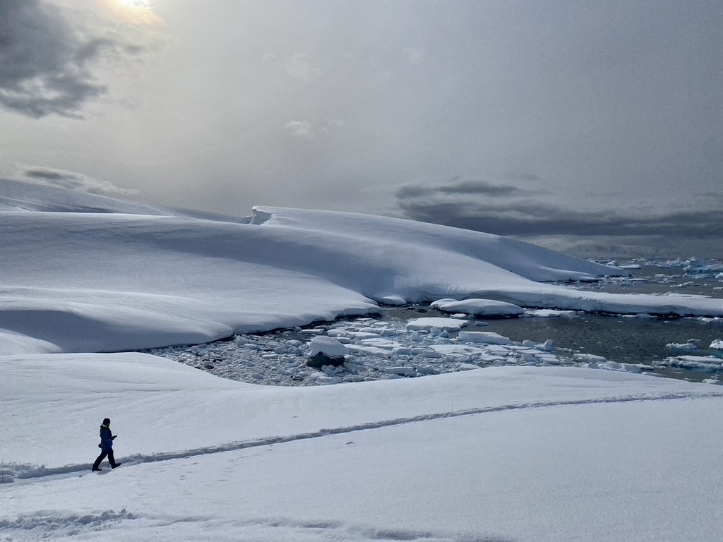 A woman walks through the snow in Antarctica 