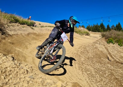 A woman bikes down a mountain in France