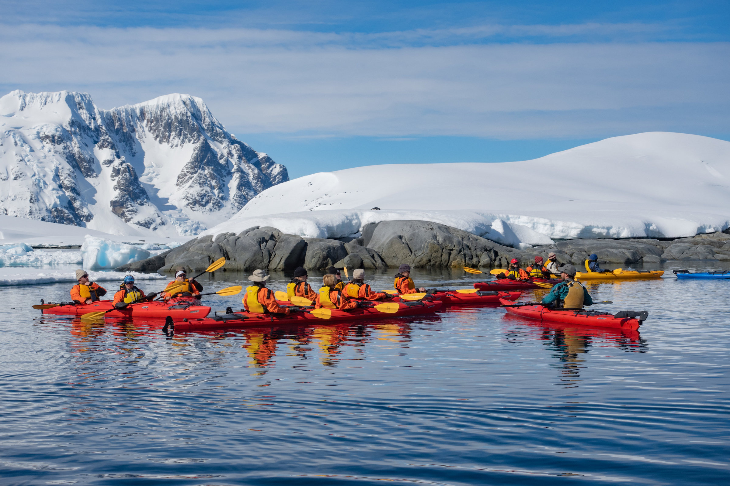 A group of kayakers off Pleneau Island in the Antarctic Peninsula