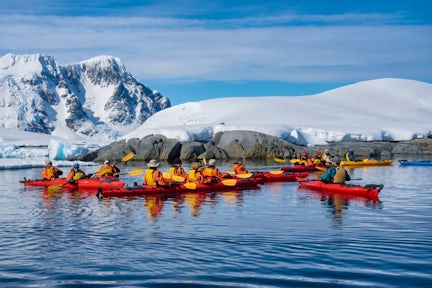 A group of kayakers off Pleneau Island in the Antarctic Peninsula