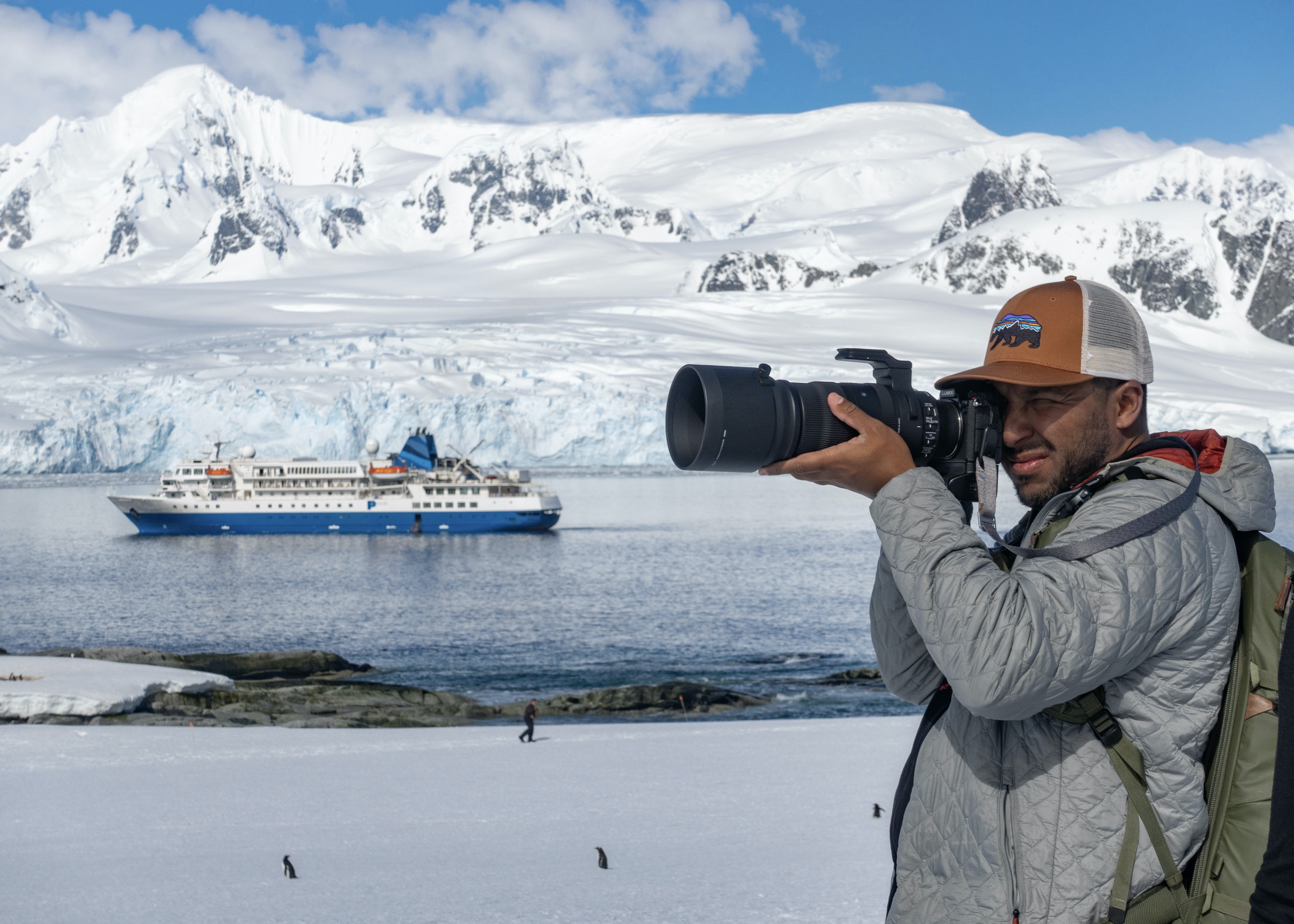 A photographer takes his shot on Petermann Island, with Seaventure in the background