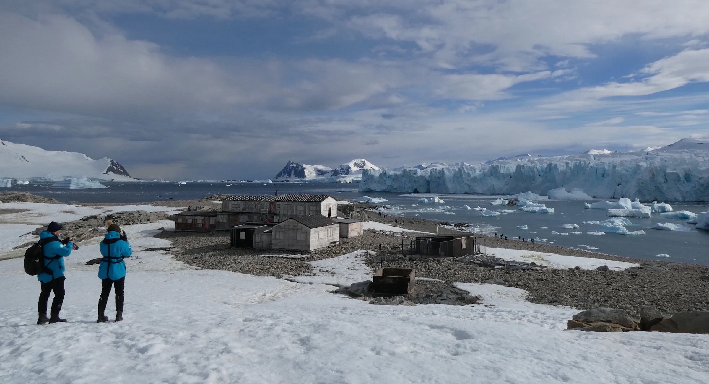 Tourists at the huts of Station E on Stonington Island in Antarctica