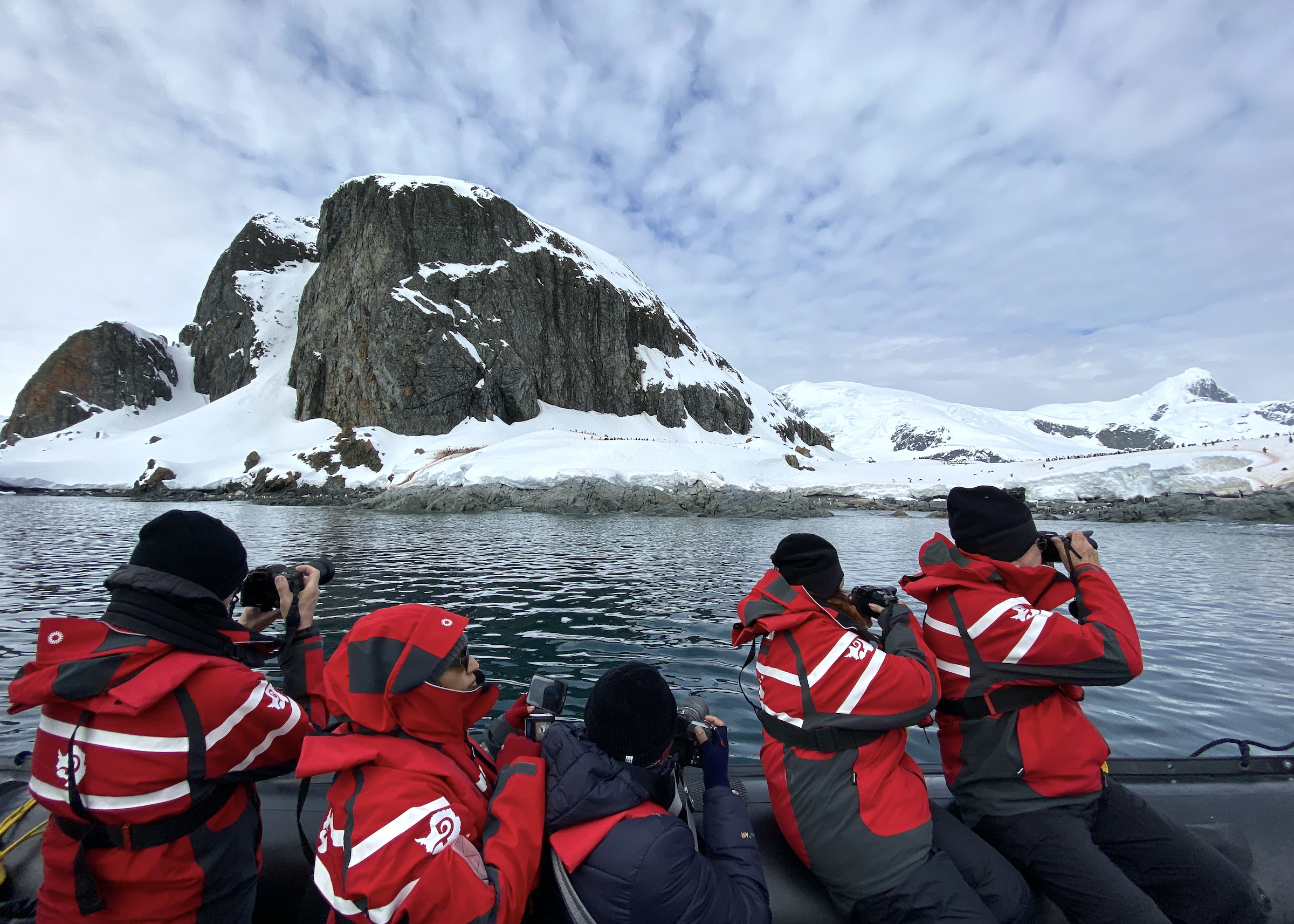 A zodiac with photographers  off Cuverville Island