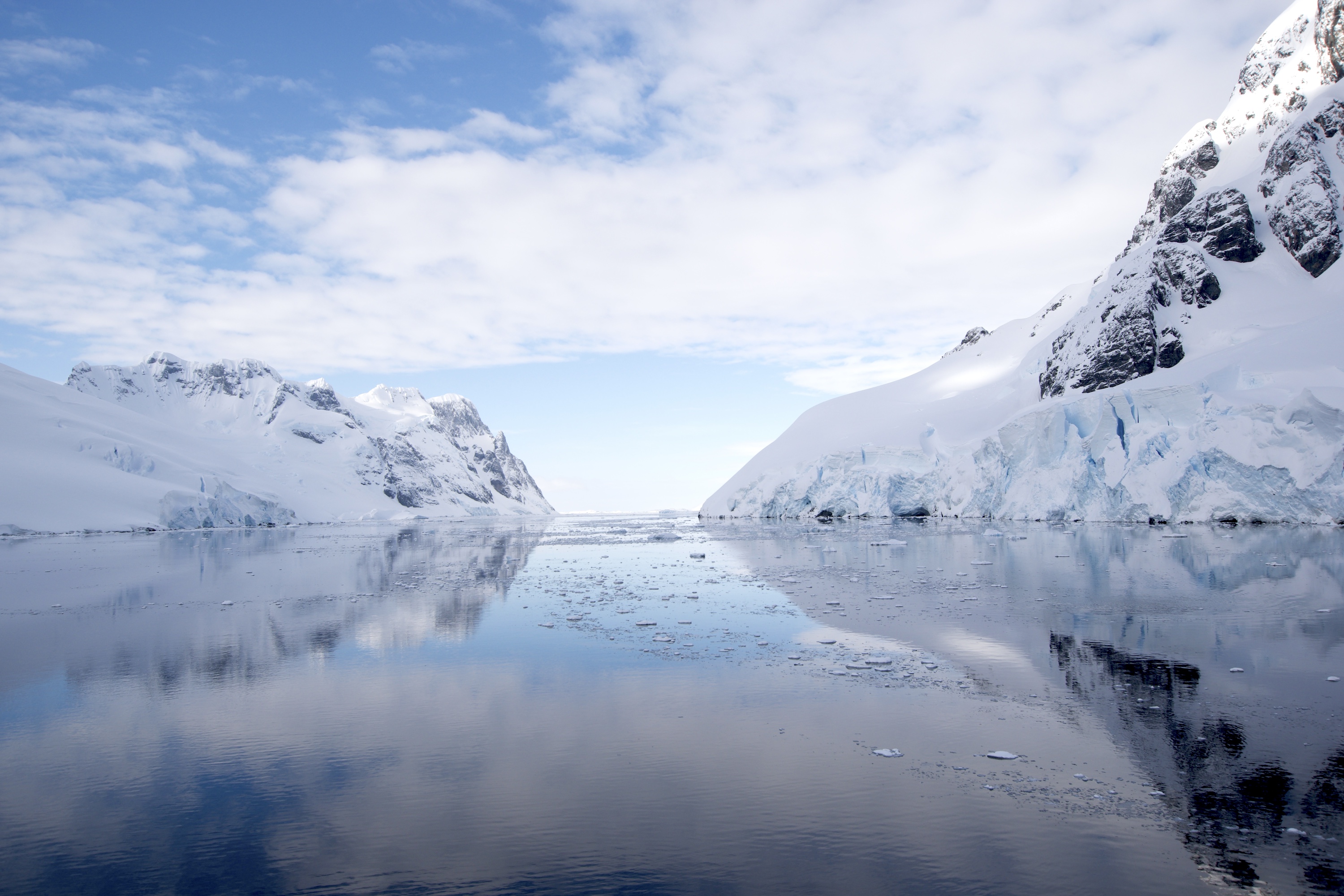 A view of the calm waters and icy scenery of the Lemaire Channel in Antarctica 