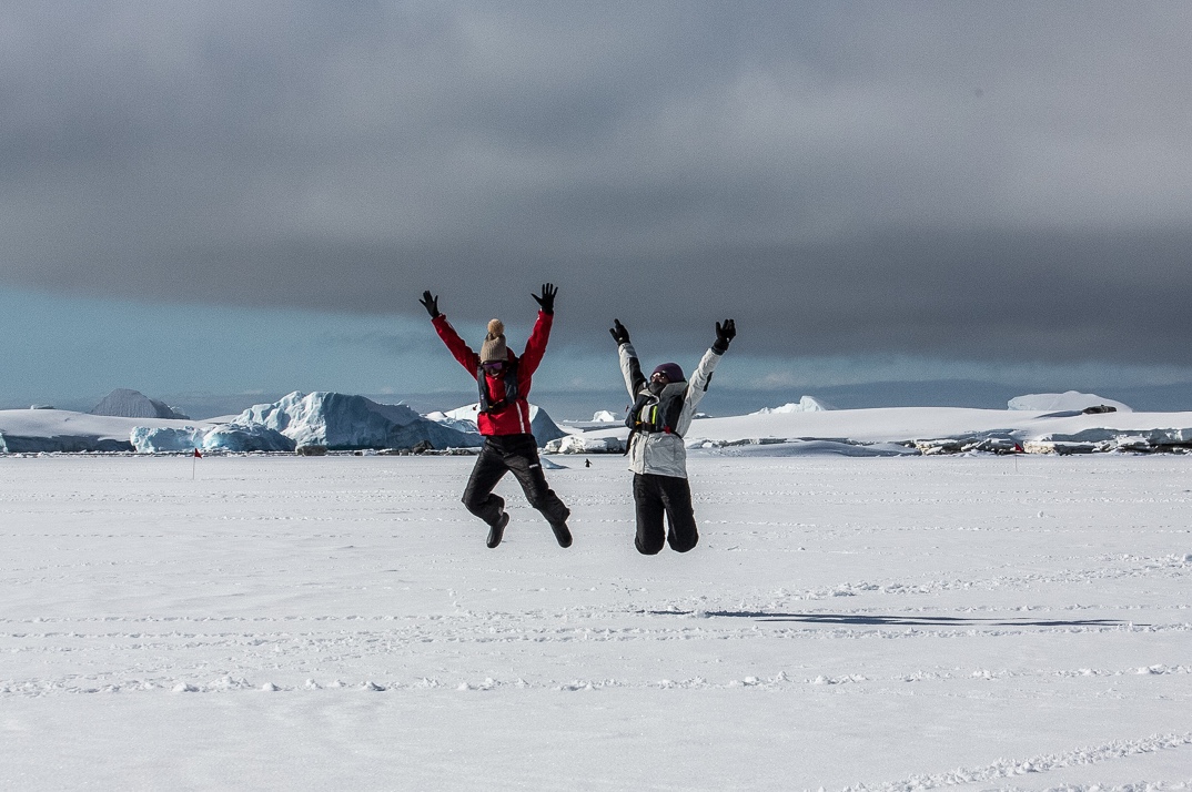 Two people jump for joy after reaching the Antarctic Continent 