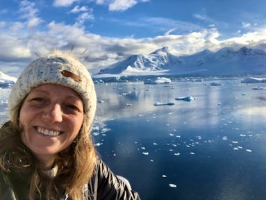 Woman smiling surrounded by Antarctic scenery