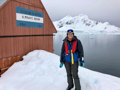 Woman standing by Base Brown in Antarctica