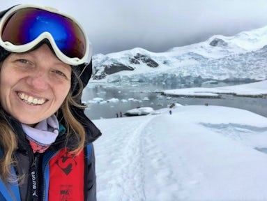 Woman smiling surrounded by Antarctic scenery