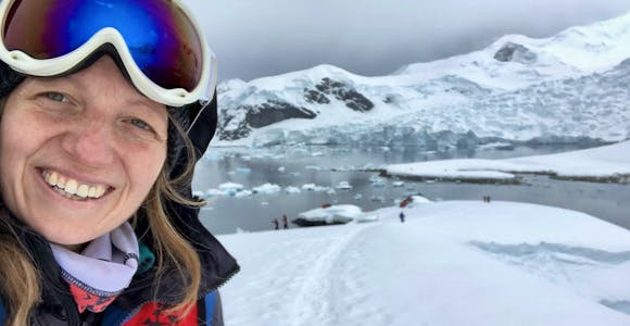 Woman smiling surrounded by Antarctic scenery