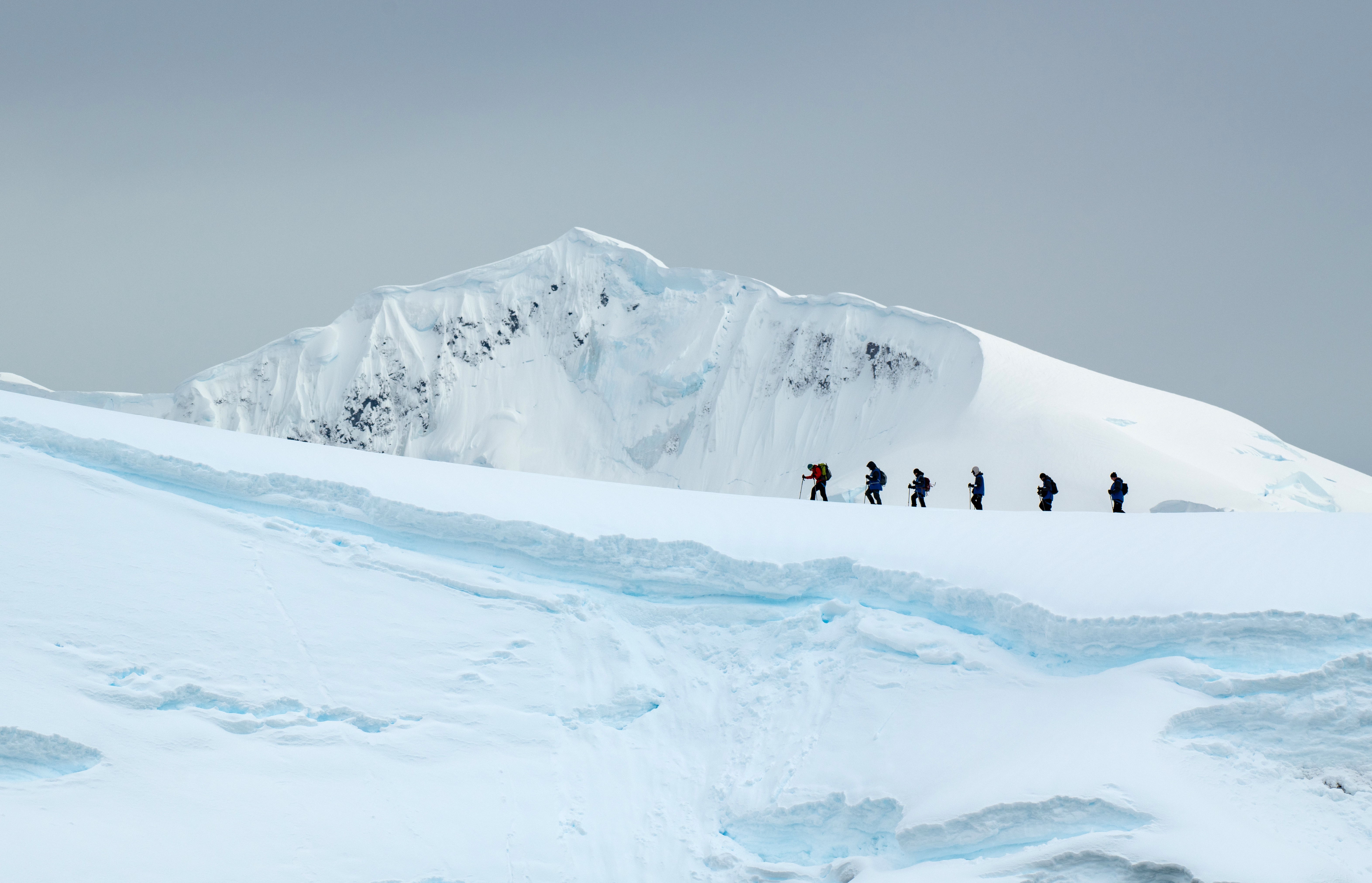 Hikers cross a ridge in Antarctica